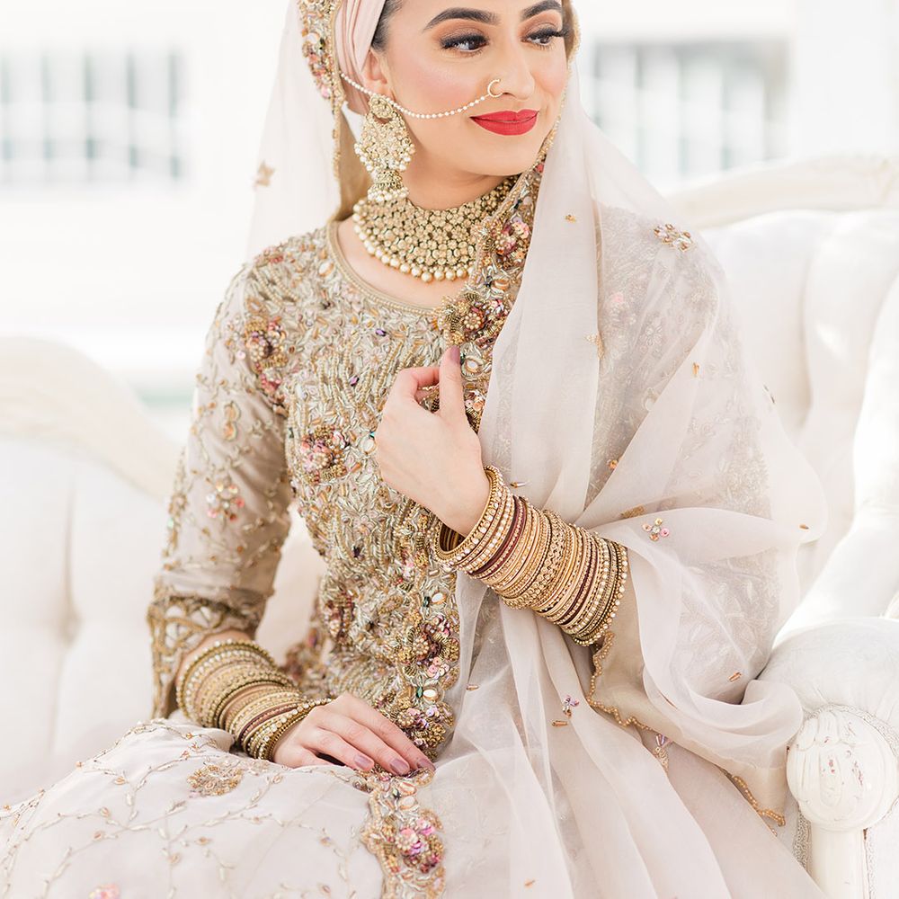 Bride wears traditional jewellery on her wedding day and red lipstick 