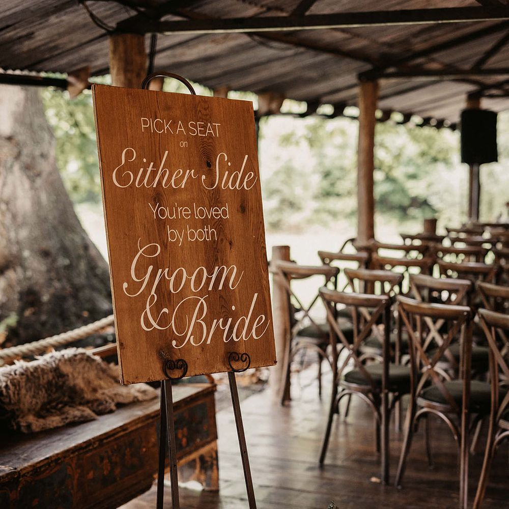 Rustic styled wedding signage on easel at The Dreys wedding venue for barn ceremony 