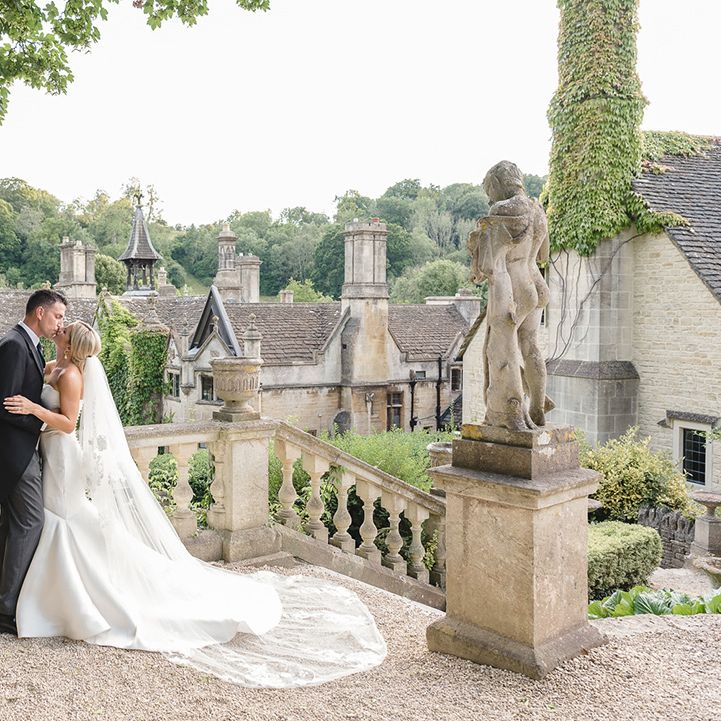 The Manor House, Castle Combe wedding venue with the bride in a mermaid wedding dress and groom in morning suit 