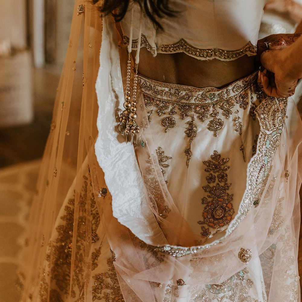 Bride wearing gold sparkly lehenga for the interfaith wedding blessing 