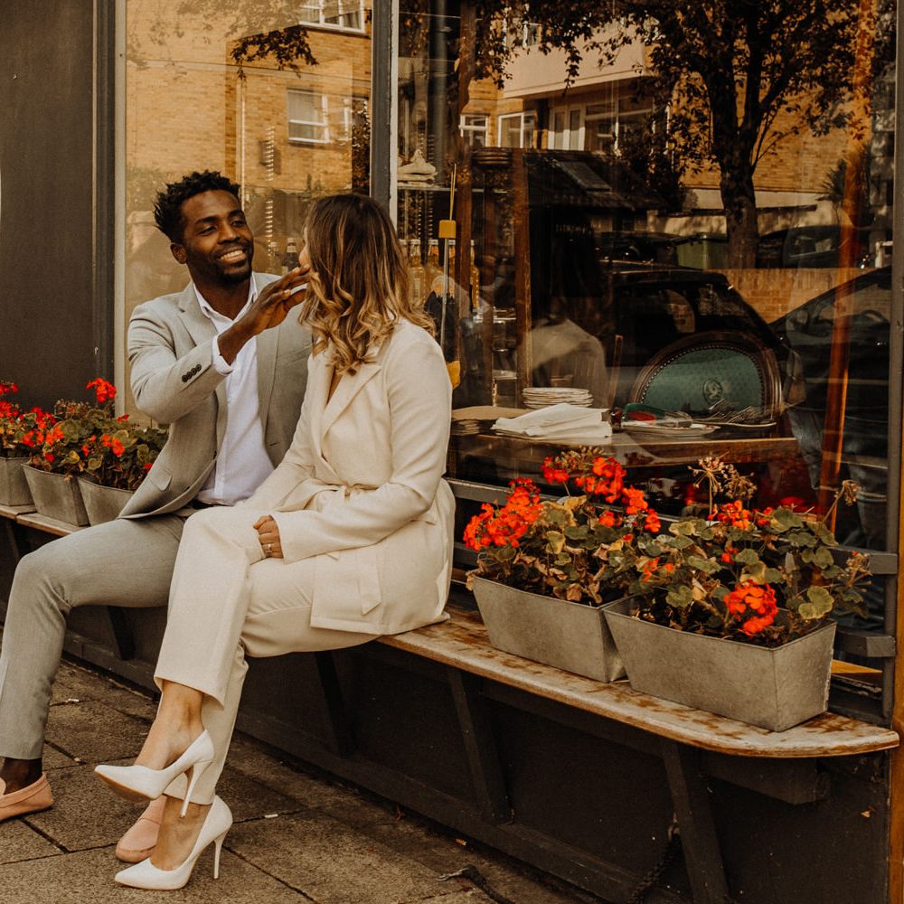 Bride and groom laughing outside their favourite cafe in Portsmouth 
