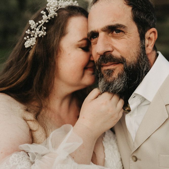 Bride leans into Groom's face in Tuscany olive grove