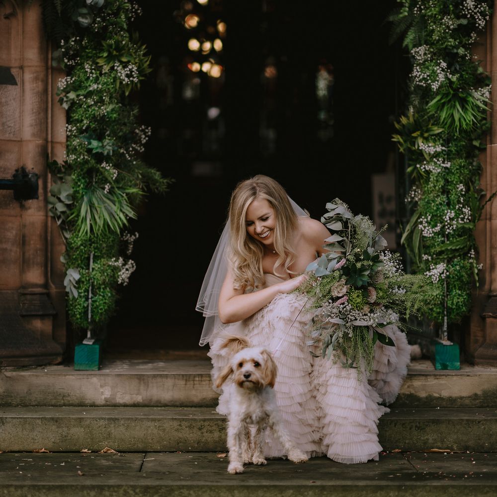 Bride pets her dog at church wedding