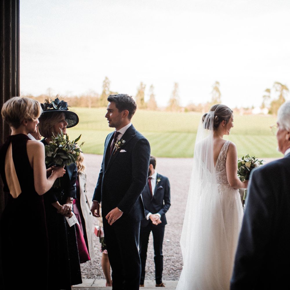 Bride & groom mingle outdoors after wedding ceremony