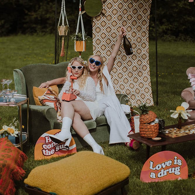 Outdoor seating area for Sixties wedding with retro prints, vintage furniture and cushions in bold colours