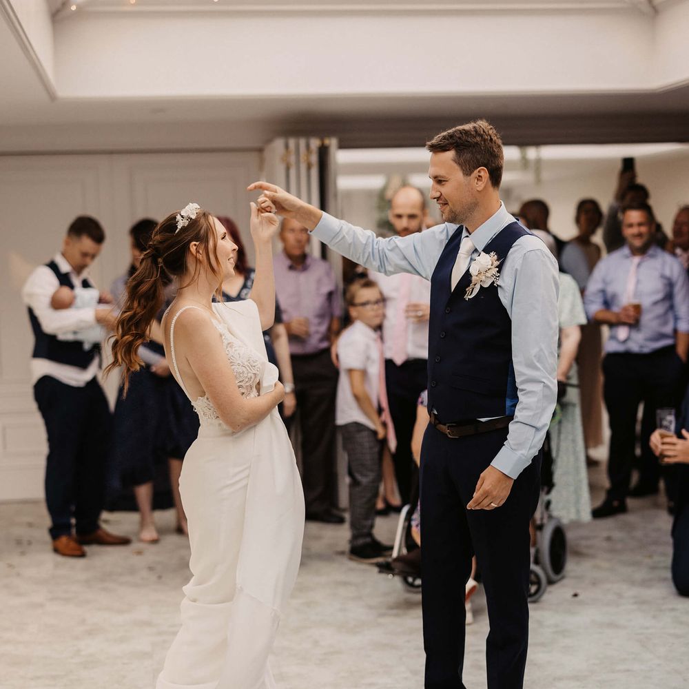 Bride & groom dance during wedding reception 