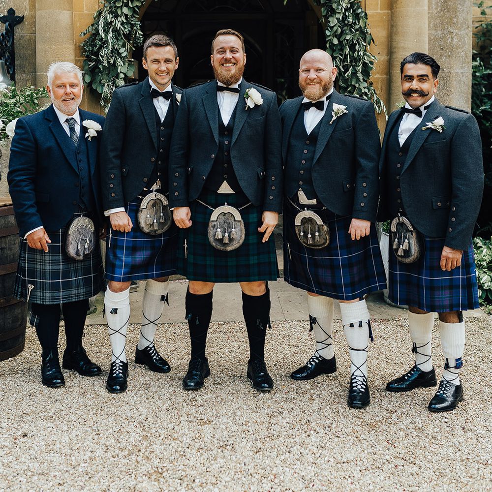 Groom and groomsmen in blue tartan kilts and sporrans at Foxhill Manor 