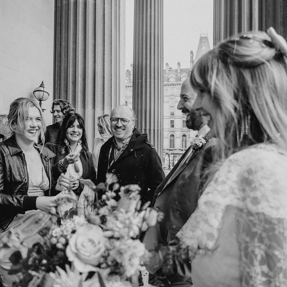 Bride & groom stand outside St. George's Hall, Liverpool after intimate civil ceremony with family
