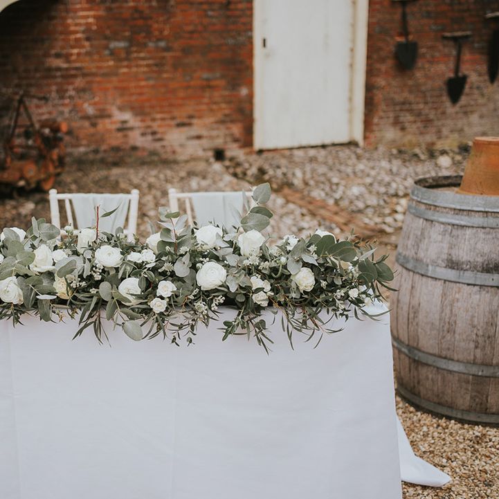 White sweetheart table for the bride and groom to sign the wedding register 