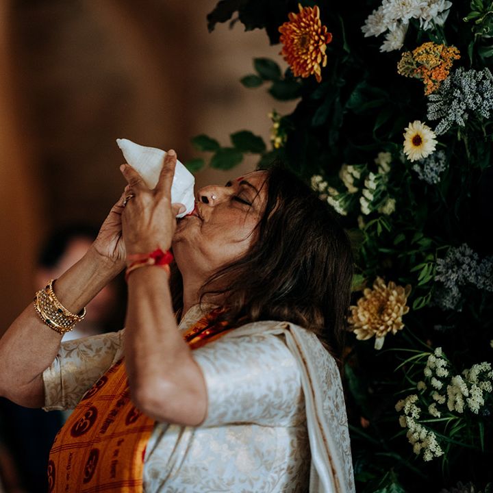 Wedding guest drinks during multicultural ceremony at The Tithe Barn Bolton Abbey 