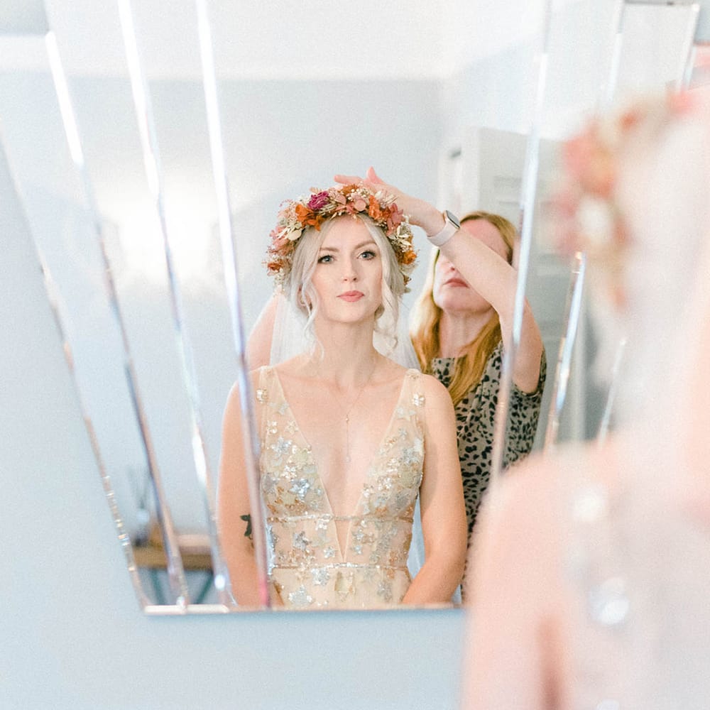 Bride wears sequin embellished wedding dress with Autumnal coloured flower crown in her blonde hair 