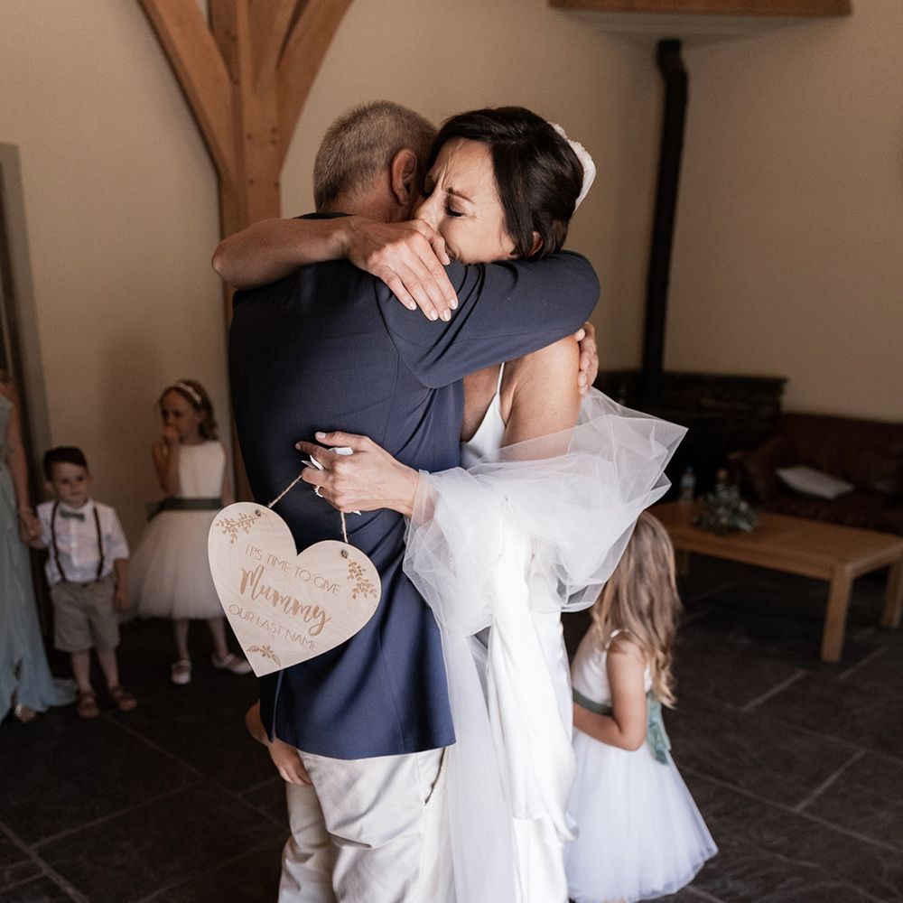 Chloe Bruce bride hugs her father on the morning of her wedding day during first look moment 