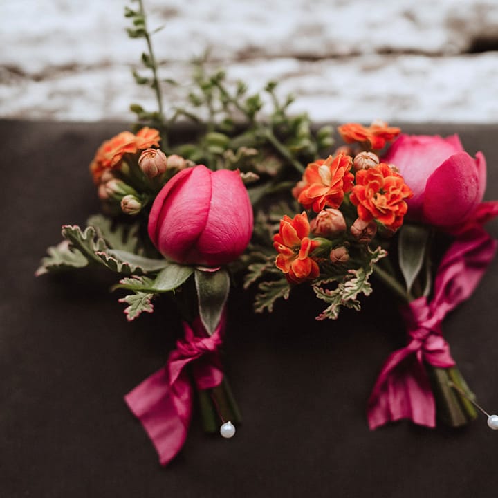 Orange florist kalanchoe with pink roses for the groom and groomsmen buttonholes 