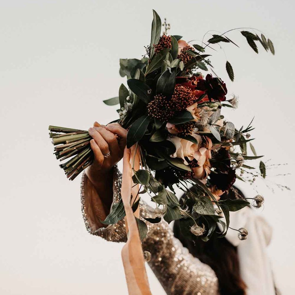 Mixed neutral bouquet with garden roses, carnations, peonies, eucalyptus, baby's breath and dried flowers tied with mustard velvet ribbon 