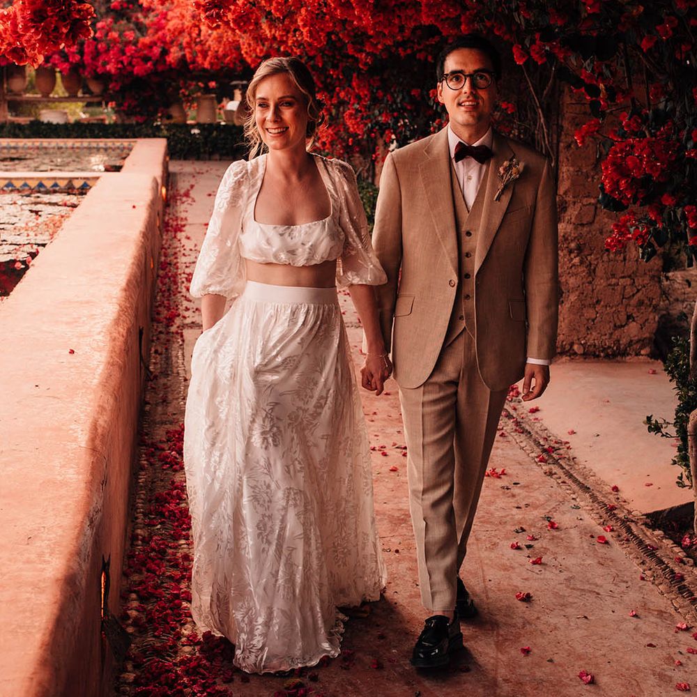 Gorgeous couple portrait of Marrakech wedding with the bride in a long sleeve and maxi skirt bridal separates with the groom in cream suit 