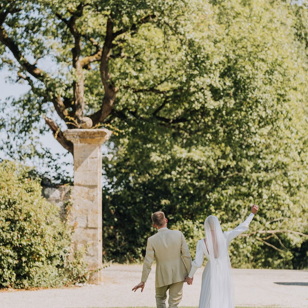 French destination wedding at Château de Malliac wedding venue with bride in a floor length veil