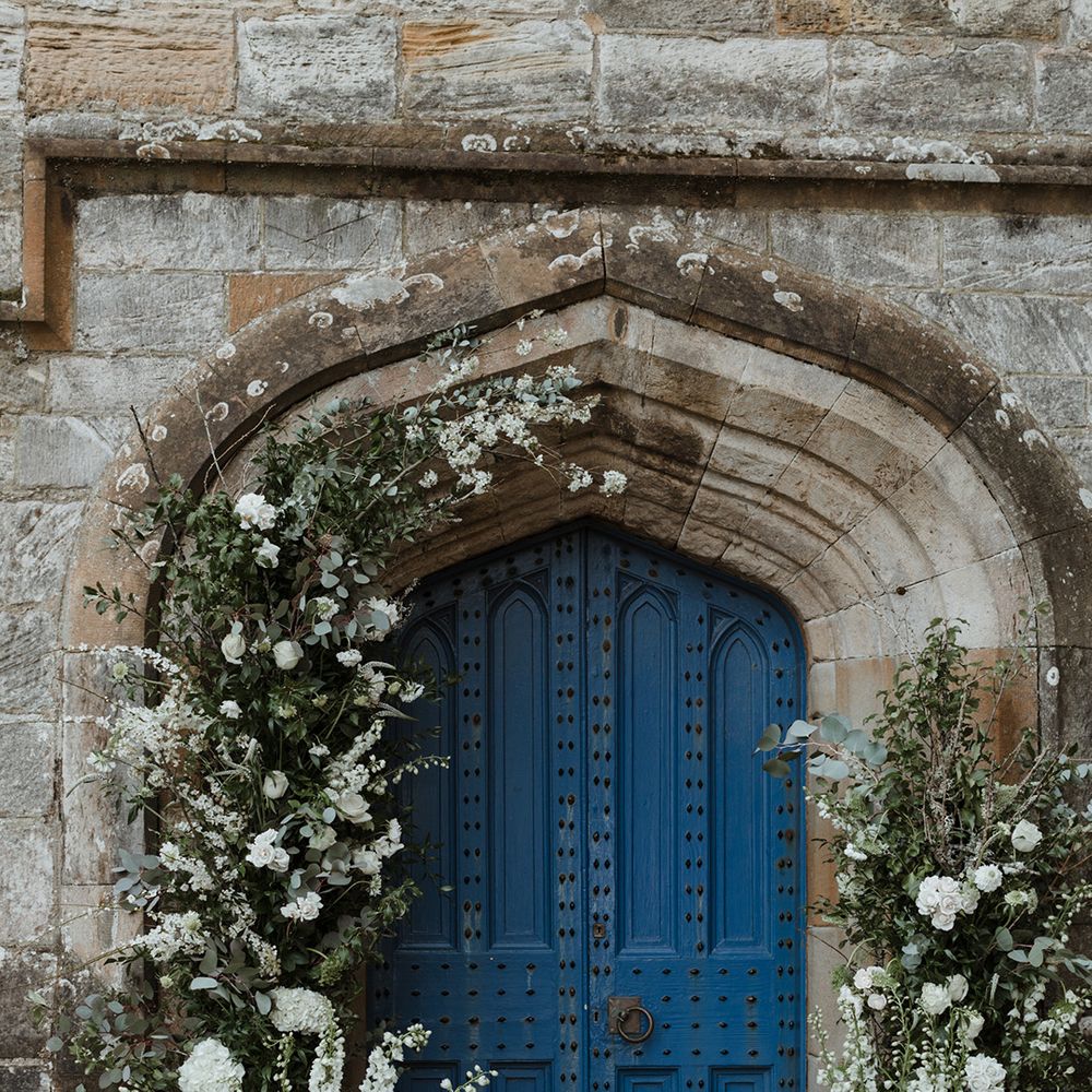 White wedding flower column arrangements for the church entrance decoration 