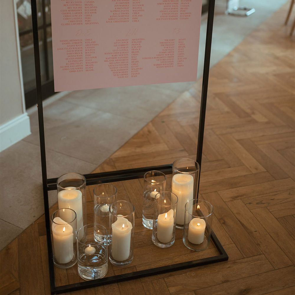 Pink and white wedding seating plan for the country house hotel wedding in Wiltshire with pillar candle decorations