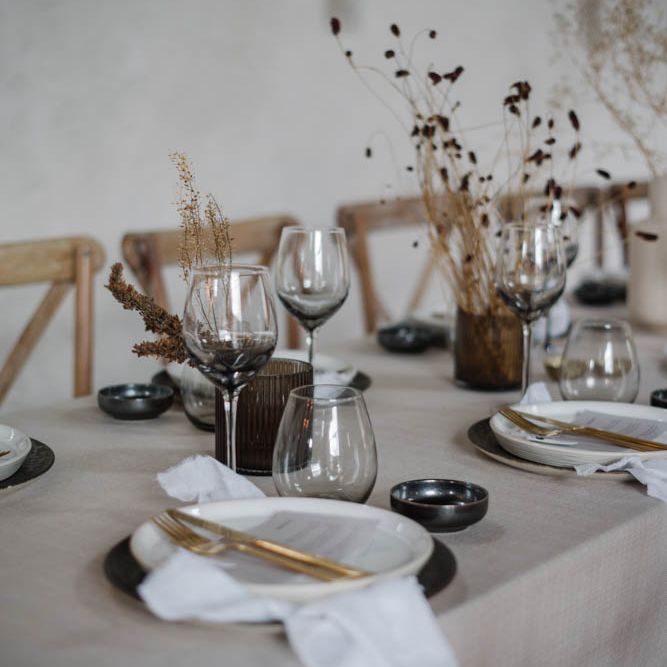 Tablescapes with smokey glass wear and minimalist flower stems 