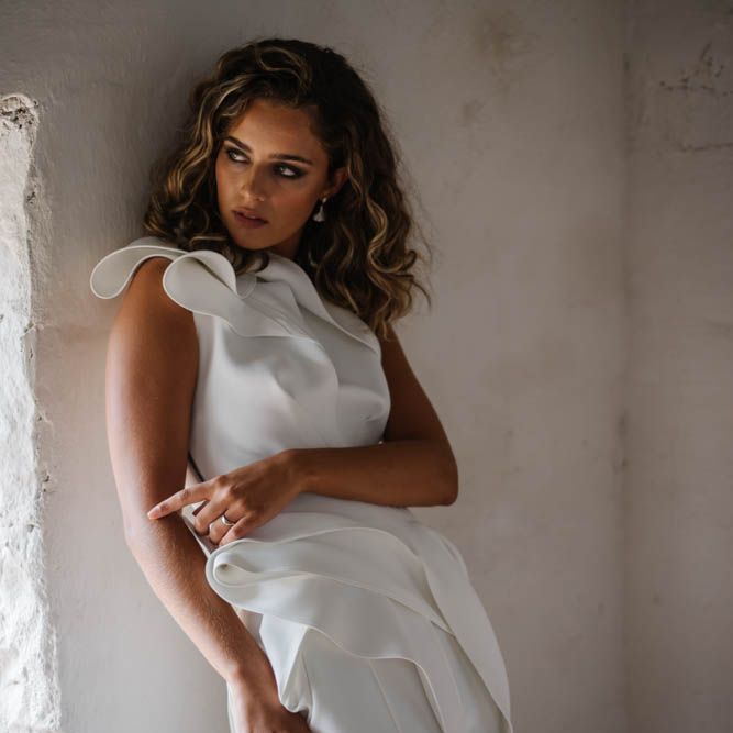 Bride in one shoulder jumpsuit with ruffles 