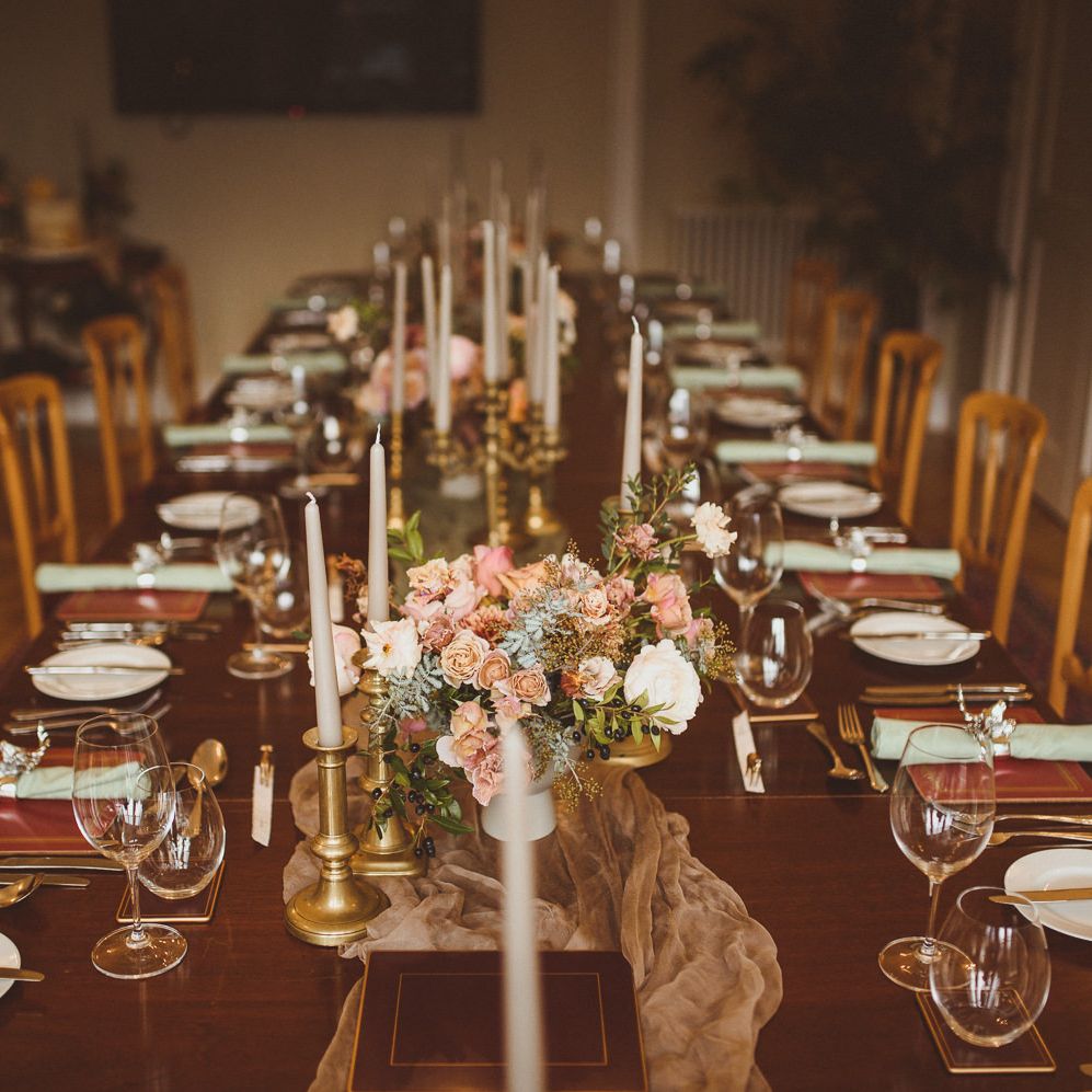Winter wedding table decor with candlesticks, taper candles and floral centrepiece 