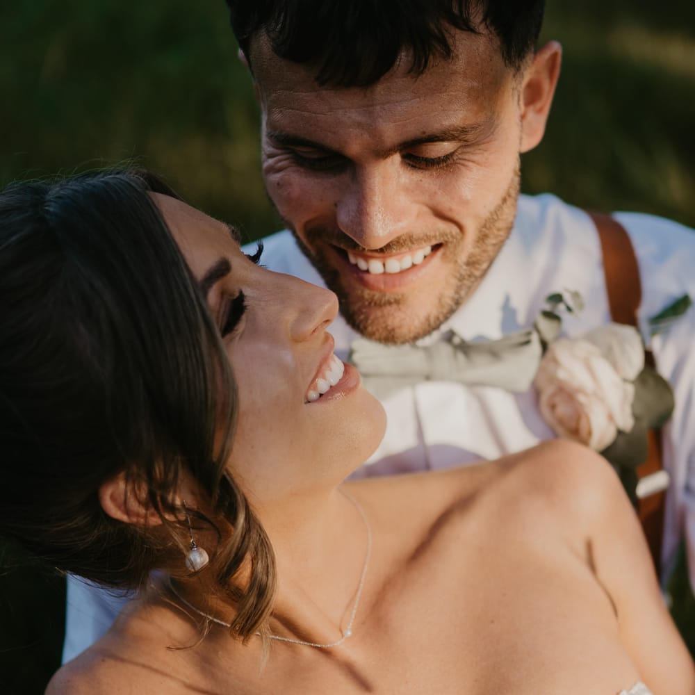 Bride looks back lovingly at her groom on her wedding day  | Mark Bamforth Photography