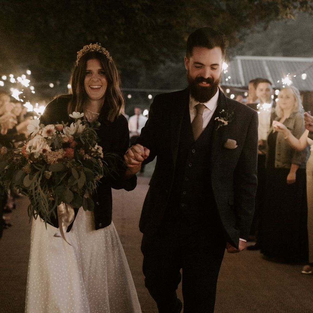 Bride & groom walk through sparkler exit on their wedding day