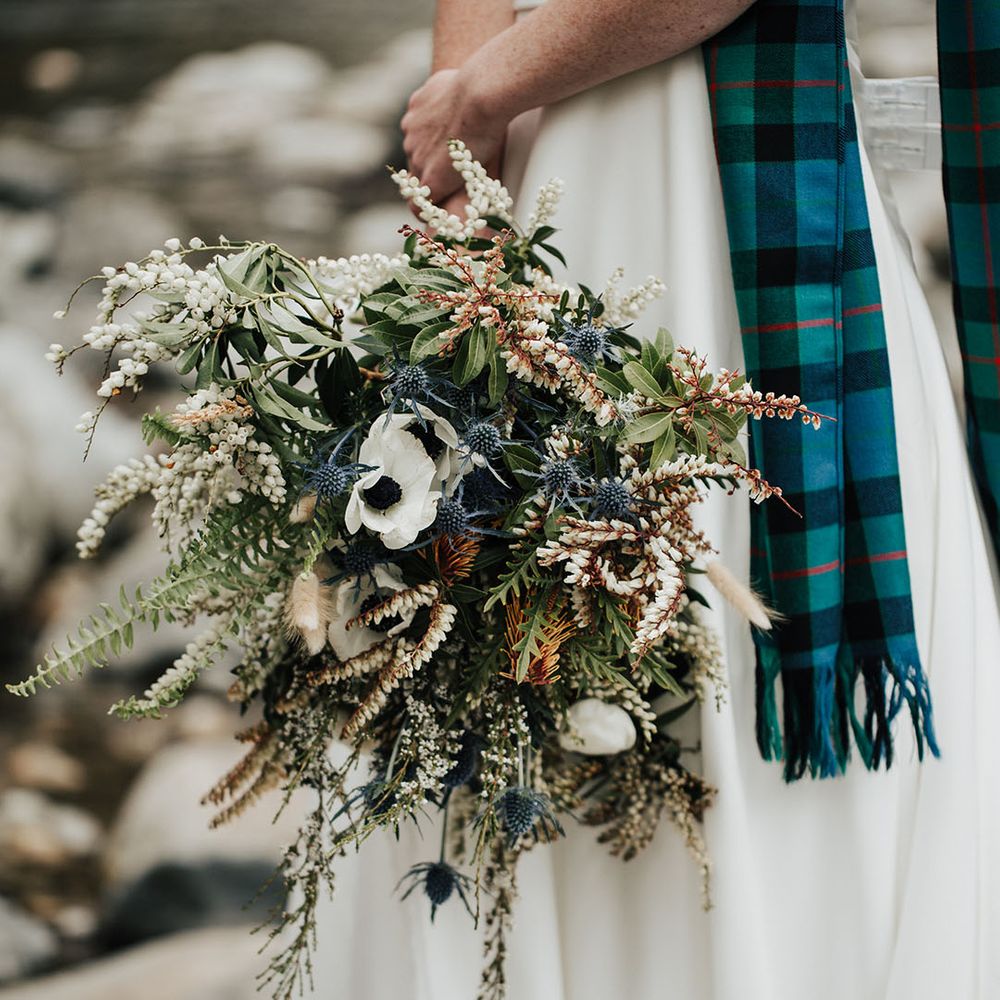 neutral wedding bouquet with anemones, thistles and wildflowers