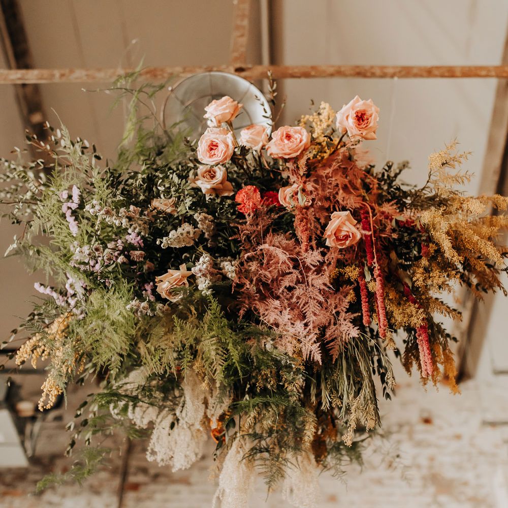 Green, pink and yellow mixed flower cloud with ferns and roses for industrial style wedding at Scale wedding venue in Liverpool