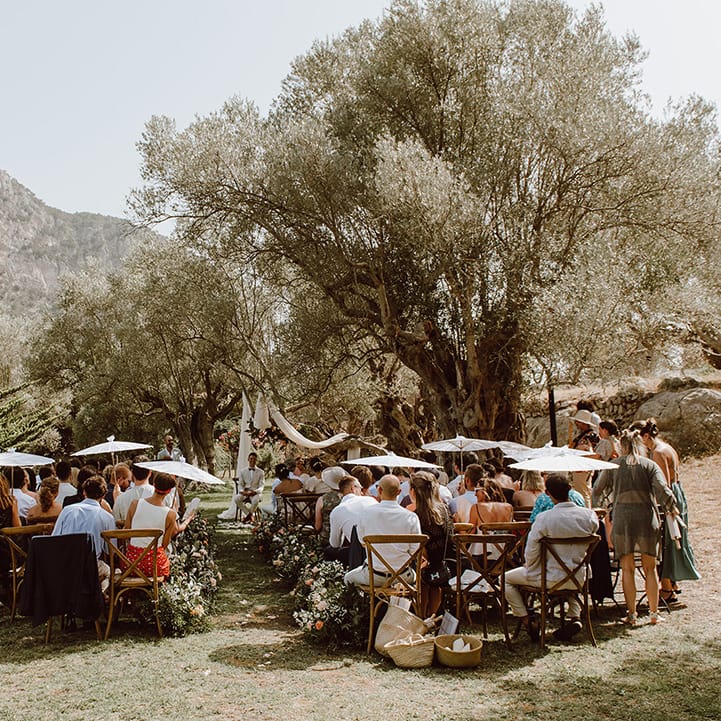 wedding guests and groom await for arrival of the bride at destination wedding
