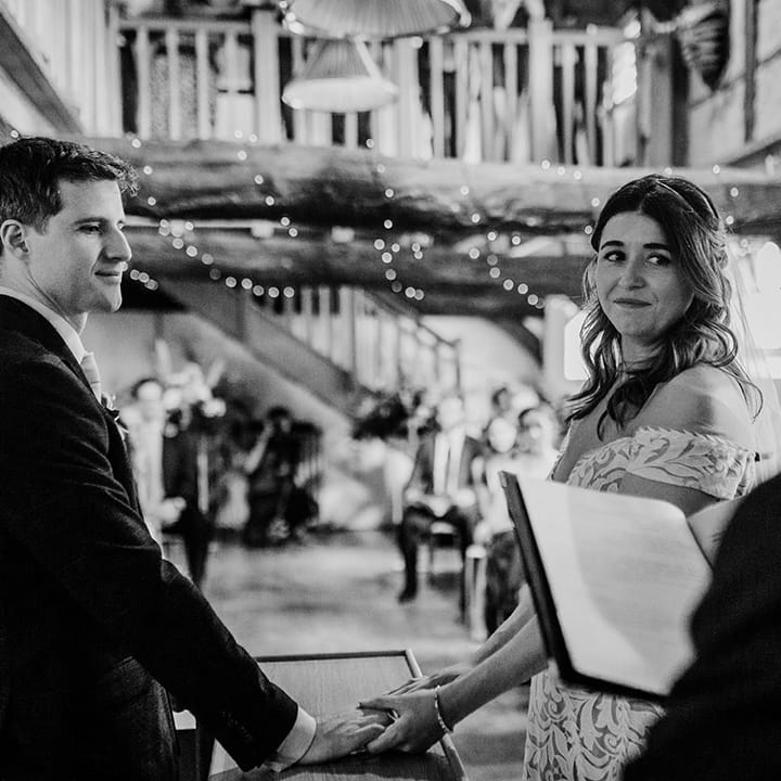 Bride and groom hold hands for their wedding ceremony 