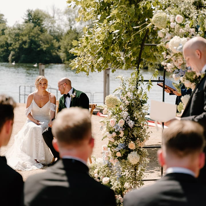 Bride & groom during outdoor wedding ceremony on the bank of the River Thames
