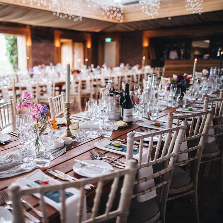 Simple and clean wedding tablescape with pops of green from the menu and wedding stationery and lollipop wedding favours 