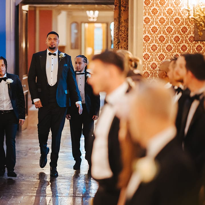 Bridal party wearing classic black tuxedos at black tie lesbian wedding at Grittleton House