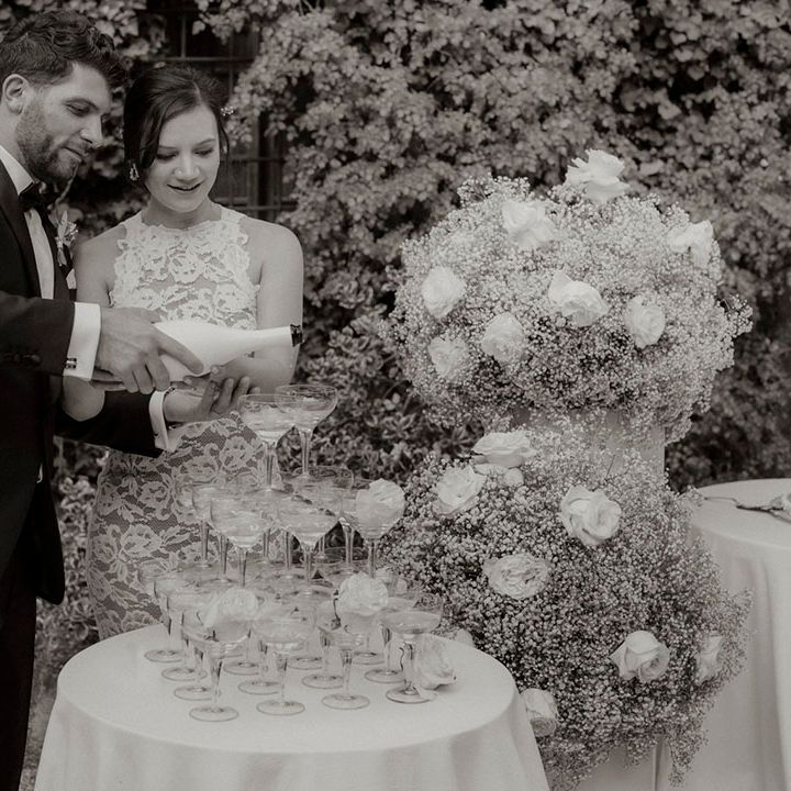 Classic champagne tower wedding decor at intimate dinner party wedding 