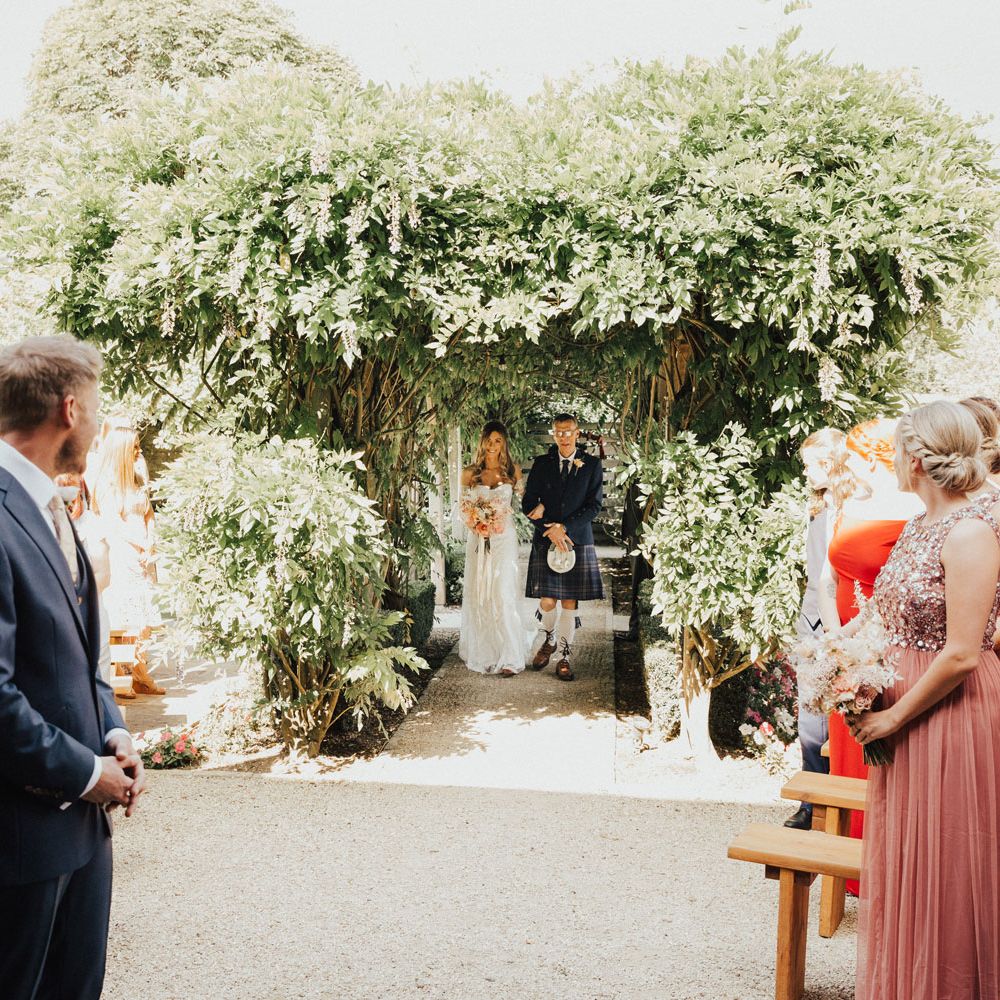Groom sees bride for the first time as she walks up the aisle with her father 