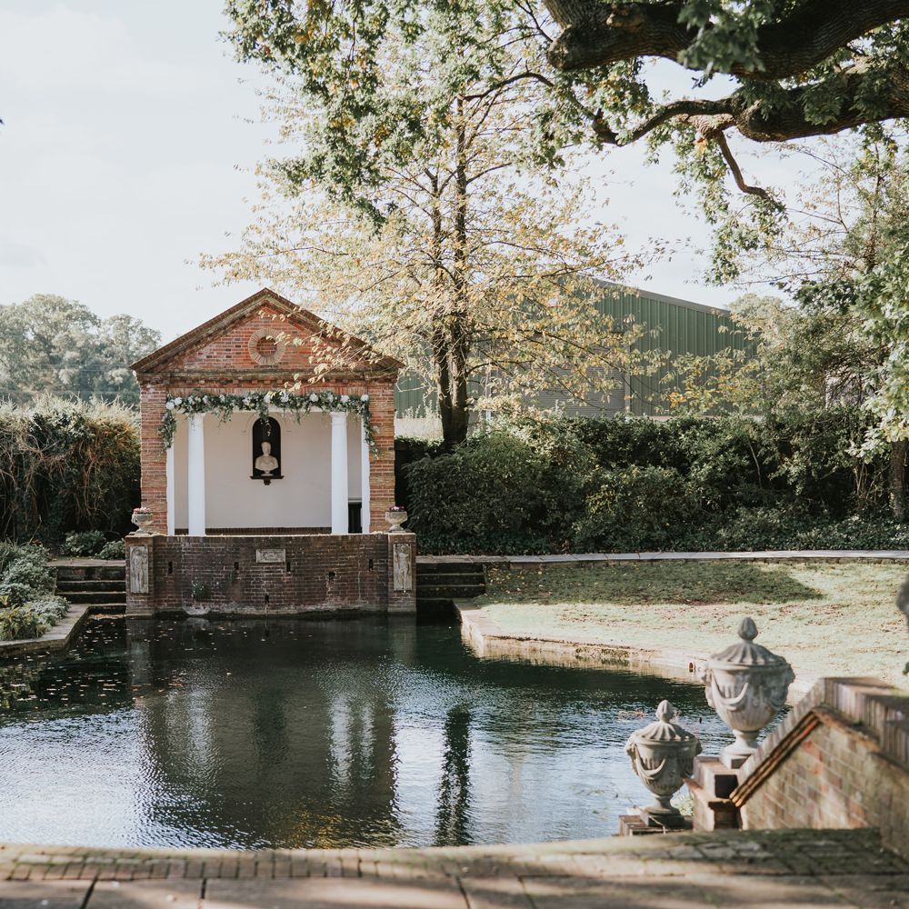 Steps lead to large pond with ceremony venue at the end
