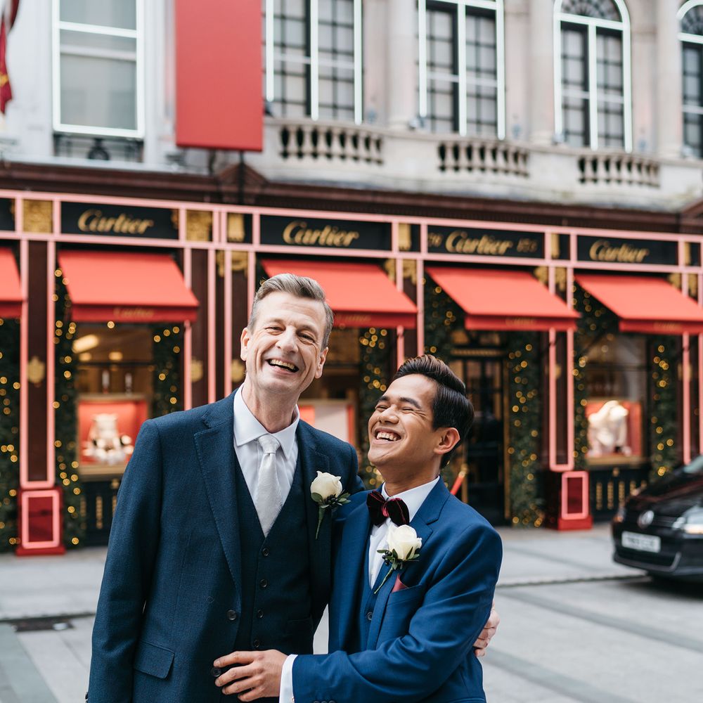 Grooms embrace in London before wedding ceremony
