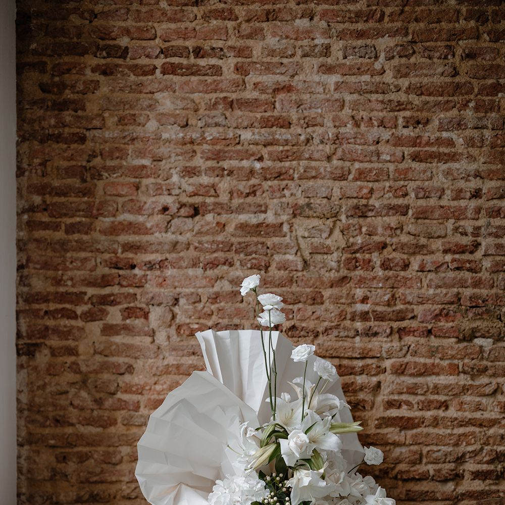 All white wedding decor with orchid wedding flowers and paper fan