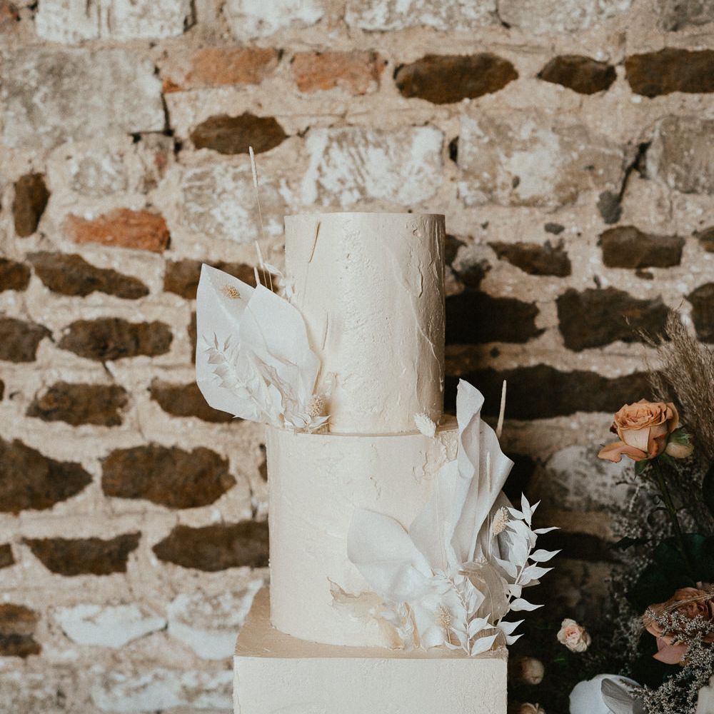 Round and square three tier buttercream wedding cake with floral design 