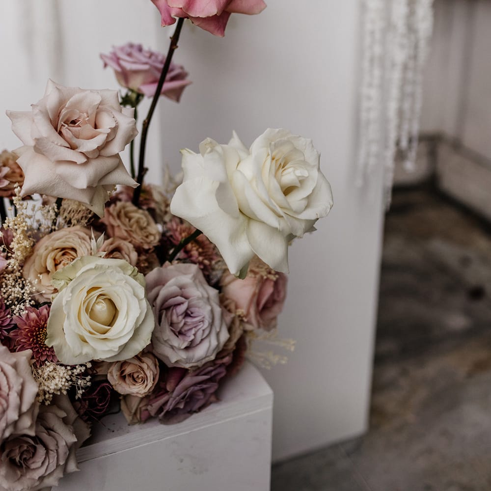 Blush pink, dusky pink and white peeled back rose floral arrangements for luxury outdoor wedding 