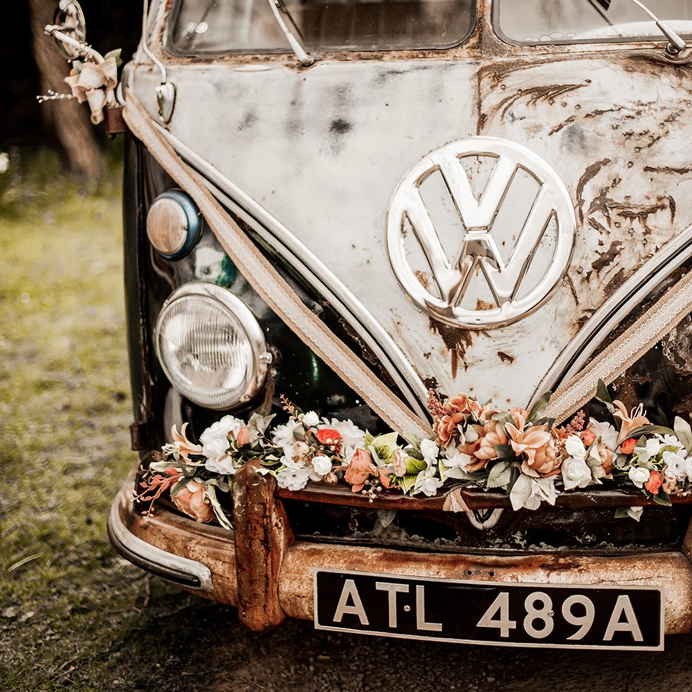 VW camper van decorated with flowers on the bumper 