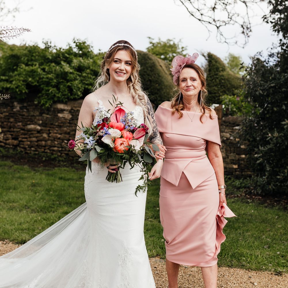 Bride walks with her mother on her wedding day