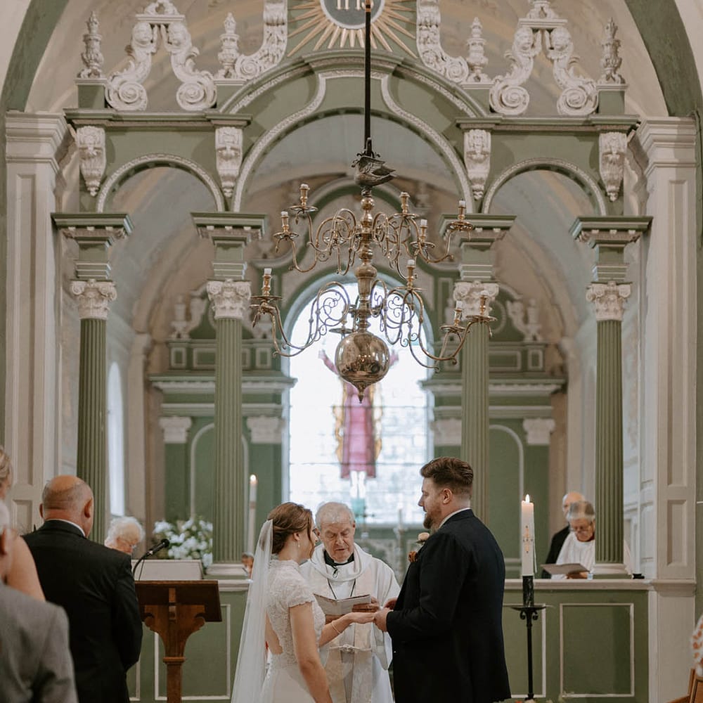 Bride and groom exchange vows at altar