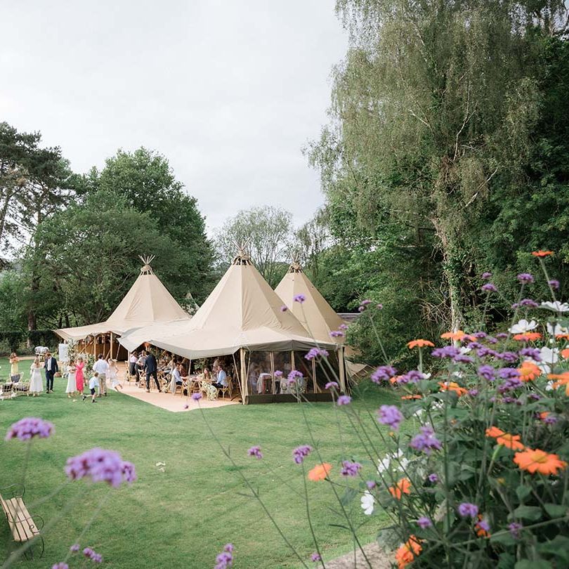 Buffalo Tipi for back garden wedding with expansive view of English countryside and flowers