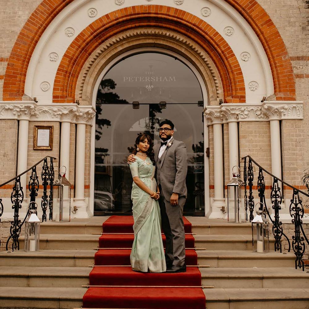Bride and groom standing outside The Petersham Hotel in Richmond