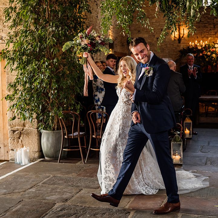 Bride and groom celebrate as they walk out of their wedding ceremony as a married couple
