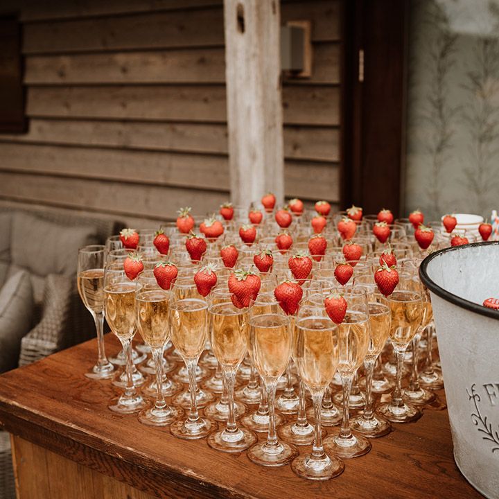 Outdoor bar area with glasses of champagne and strawberries for drinks 