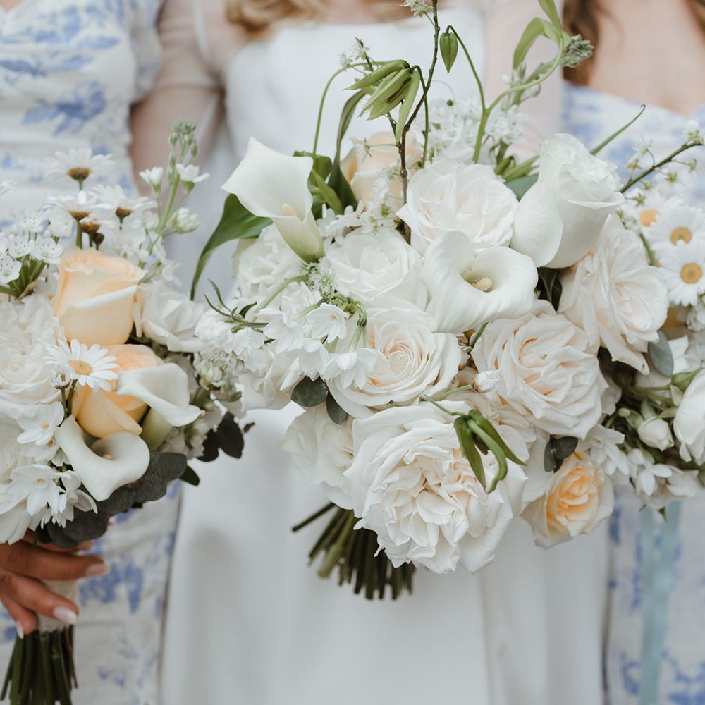 White flower wedding bouquet with roses and lilies 