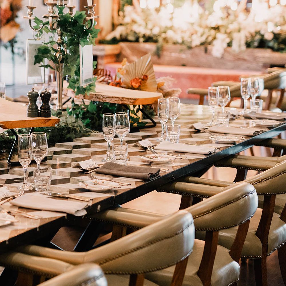 Minimalistic tablescape at Northern Ireland wedding venue with tall candelabra and foliage 